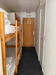 a small room with two bunk beds and a door at Studio Tignes Val Claret in Tignes