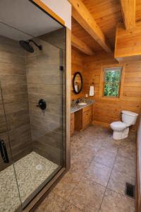 a bathroom with a toilet and a glass shower at Wilderness retreat in Marion +29 photos