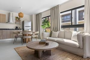 a living room with a white couch and a table at Atabey II – Epic Residence, Bávaro in Punta Cana