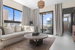 a living room with a couch and a table at Atabey II – Epic Residence, Bávaro in Punta Cana