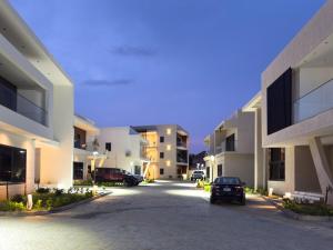an empty parking lot in the middle of some apartment buildings at Serenity Suite in Accra