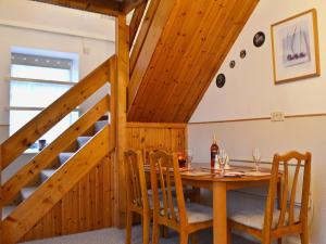 a dining room with a table and a staircase at Bakehouse Cottage in Balnald