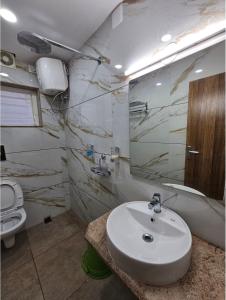 a bathroom with a sink and a toilet at V3 Inn Private Limited in kolkata