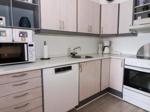 a kitchen with white cabinets and a sink at 6 person holiday home in Hadsund in Hadsund