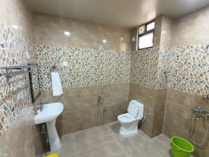 a bathroom with a toilet and a sink at Ankush Resort in Vishnupur