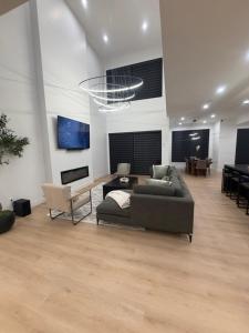a living room with a couch and a table at Downtown Luxe Stay - High River in High River