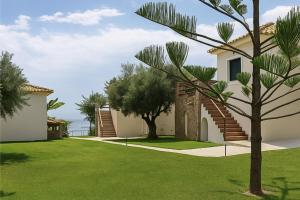 a house with a green yard with a tree at Panorama Beach in Chrani