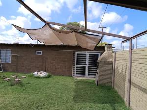 a mosquito net on the roof of a house at Hospedaje BellaVilla in Bell Ville