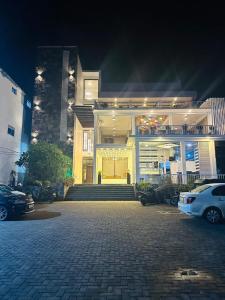 a white car parked in front of a house at Hotel Divine Light Monaragala in Monaragala