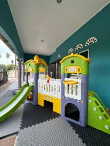 a childrens play room with a slide and a play area at Homestay D Makmur UNIT 1 in Mersing