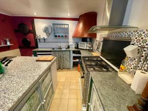 a large kitchen with a stove top oven at Bed Breakfast - Casa Rural in Úbeda