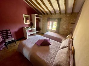 a bedroom with two beds and a chair in a room at Bed Breakfast - Casa Rural in Úbeda +33 photos