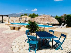 a blue table and chairs and a swimming pool at Bed Breakfast - Casa Rural in Úbeda