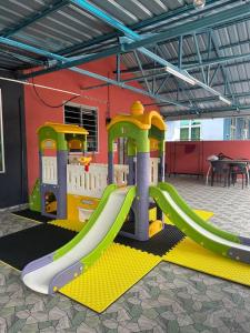 a playground with a slide in a room at Homestay D Makmur UNIT 2 in Mersing