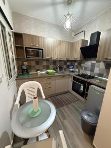 a small kitchen with a table and a stove at Dar Zina in Mteurch