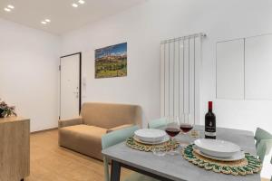 a living room with a table with a bottle of wine at House Tuscany in Poggibonsi