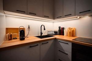 a kitchen with a sink and a counter top at Stylish Townhouse- central & quiet in Prishtinë