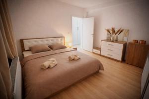 a bedroom with two stuffed animals on a bed at Stylish Townhouse- central & quiet in Prishtinë +1 photo