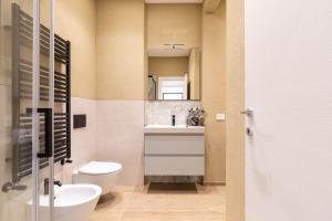 a bathroom with a toilet and a sink and a mirror at House Tuscany in Poggibonsi +6 photos
