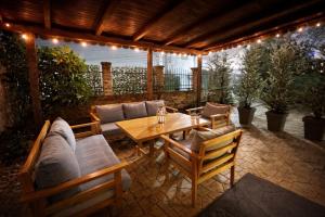 a patio with a couch and a table and chairs at Stylish Townhouse- central & quiet in Prishtinë