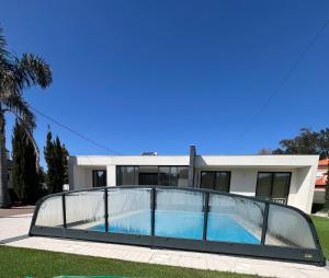 a house with a swimming pool in front of it at Meirinha House in Viana do Castelo