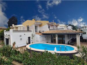 a large house with a swimming pool in front of it at Villa Nevada - Espacioso Chalet con Piscina Privada y Salita de Cine in Port de Pollensa