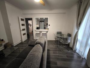 a living room with a couch and a glass table at Apartamentos Crispin Anais in Corella +4 photos