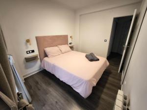 a small bedroom with a bed in a room at Apartamentos Crispin Anais in Corella