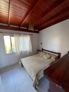 a bedroom with a large bed and a window at Ayres de Cobo in Mar de Cobo