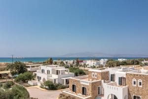 a view of a town with white buildings and the ocean at Plaka Hotel II in Plaka