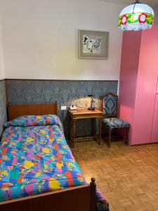 a bedroom with a bed and a table and a desk at Casa Adriana in Pradalunga