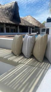 four pillows sitting on top of a balcony with a building at Hot Chipilin El Paredon in Sipacate +13 photos