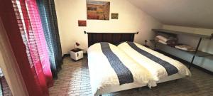 a bedroom with a large bed in a room at Le Chalet des Côtes in Cornimont
