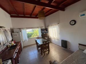 a kitchen and living room with a table and chairs at Ayres de Cobo in Mar de Cobo +21 photos