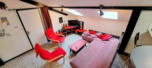 an overhead view of a living room with red furniture at Le Chalet des Côtes in Cornimont