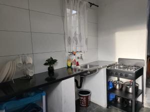 a small kitchen with a stove and a sink at 399 Place in Umtali