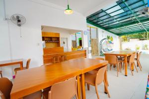 a dining room with wooden tables and chairs at SunDay Hostel in Siquijor +6 photos