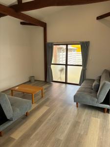 a living room with two couches and a table at 細島 Base Clutch in Hyuga