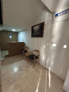 a waiting room with two chairs and a painting on the wall at Linza Suite in Babaeski
