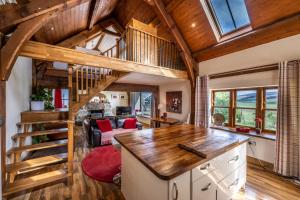a kitchen and living room with a loft at The Hideaway in Banchory