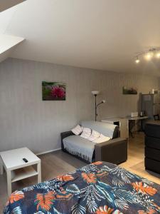 a room with two beds and a desk in it at Studio confortable proche thermes in Salins-les-Bains