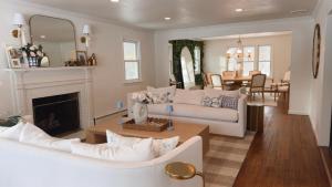 a living room with a white couch and a fireplace at Villa Après Sea in Westport