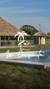 a sign for a resort with a beach at Cabaña La Conquista in Goya +1 photo