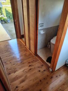 a bathroom with a toilet and a wooden floor at 玉の浦sea in Nachikatsuura +43 photos