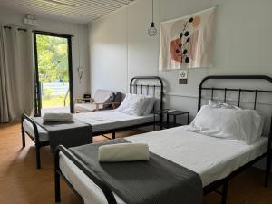 a hospital room with two beds and a window at Siqui Pods in Siquijor