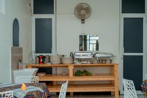 a kitchen with a wooden table with dishes on it at Mach Hotel in Dar es Salaam