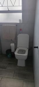 a bathroom with a white toilet in a stall at Large ensuite room in Goodwood