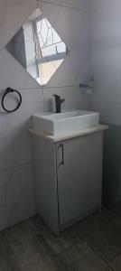 a bathroom with a sink and a mirror at Large ensuite room in Goodwood