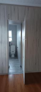 an empty bathroom with a toilet in a room at Large ensuite room in Goodwood