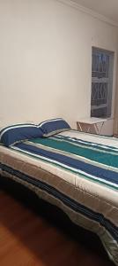 a large bed in a room with a window at Large ensuite room in Goodwood